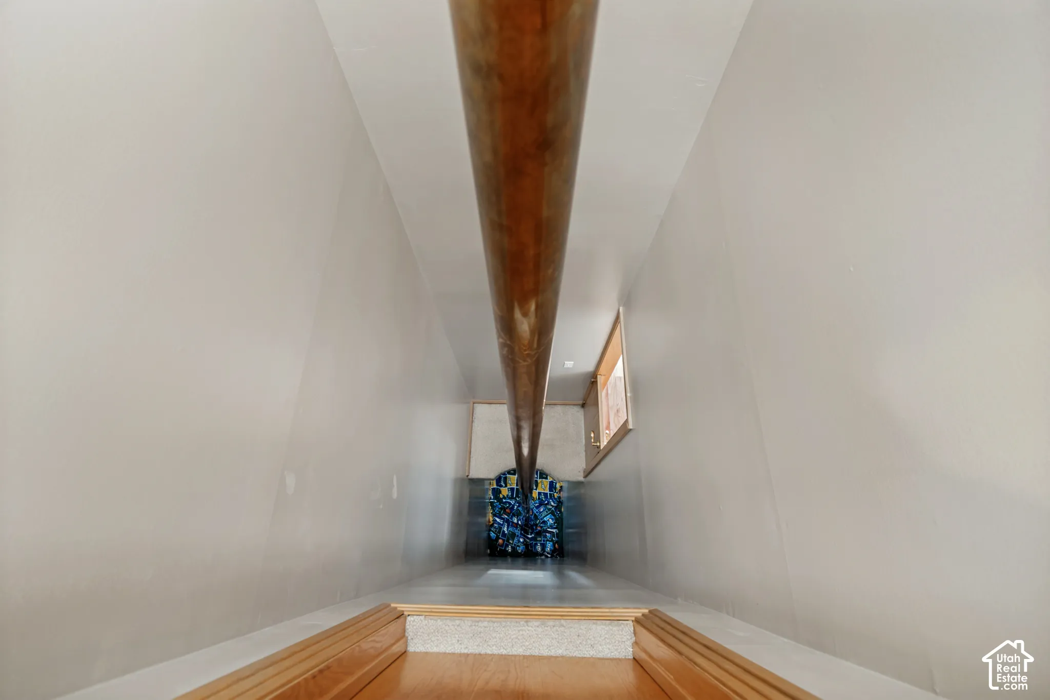 Original elevator shaft, currently configured as a fire pole.