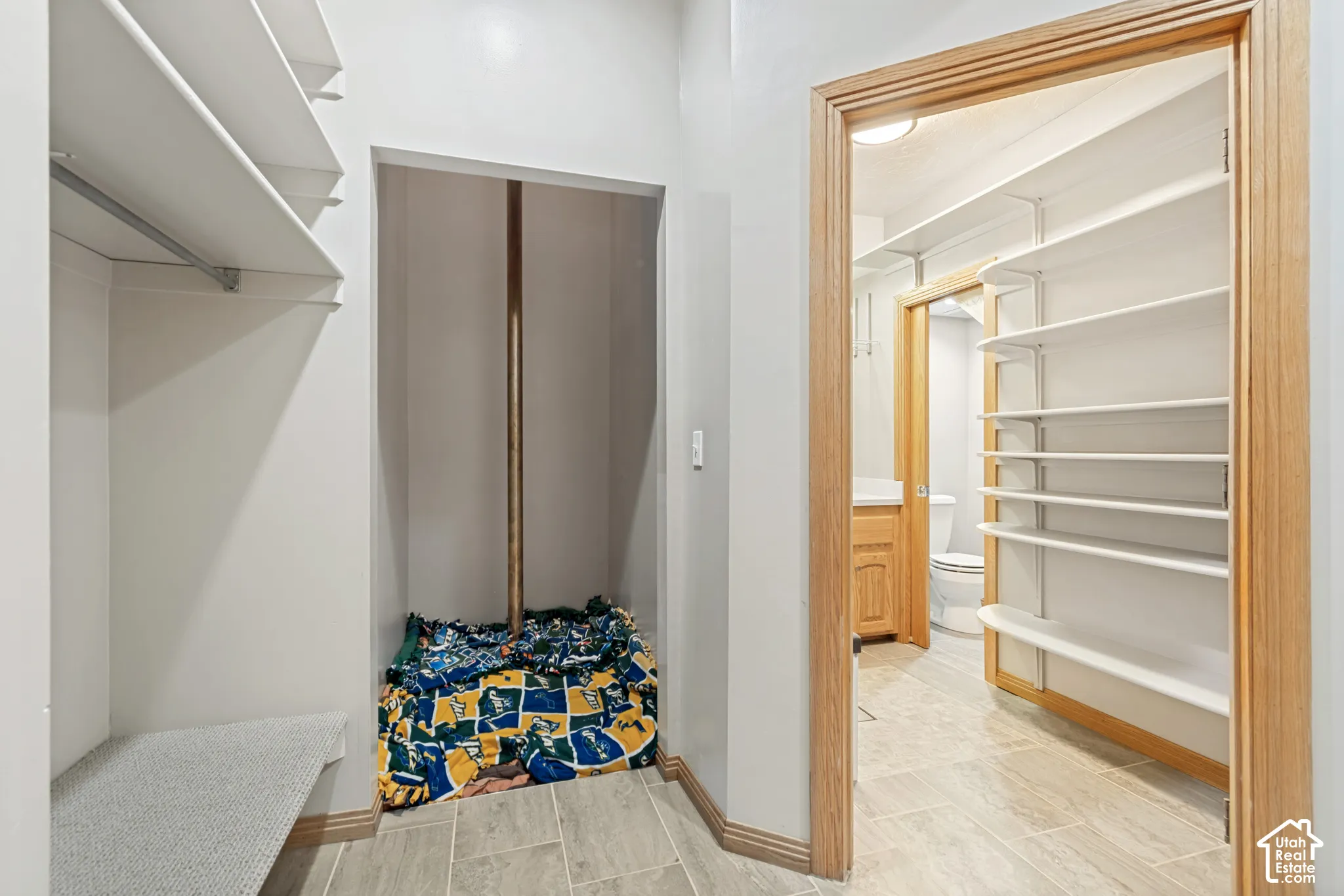 Hallway with access to original elevator shaft, currently configured as a fire pole and bathroom.