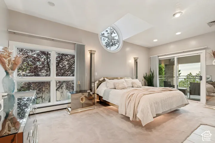 Primary bedroom with private balcony and valley views out of windows