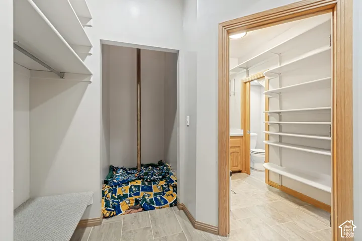 Hallway with access to original elevator shaft, currently configured as a fire pole and bathroom.