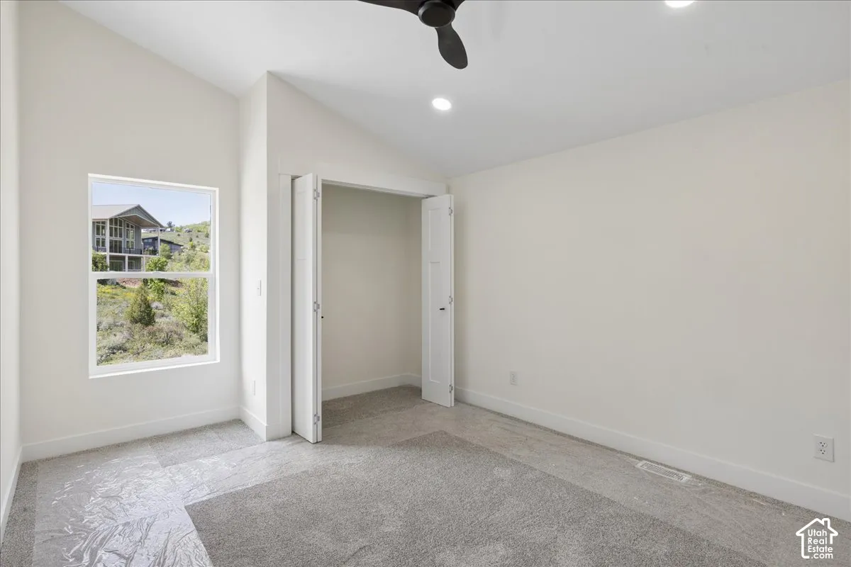 Upstairs Bedroom 2. Vaulted ceiling with recessed lighting, single window, and a ceiling fan
