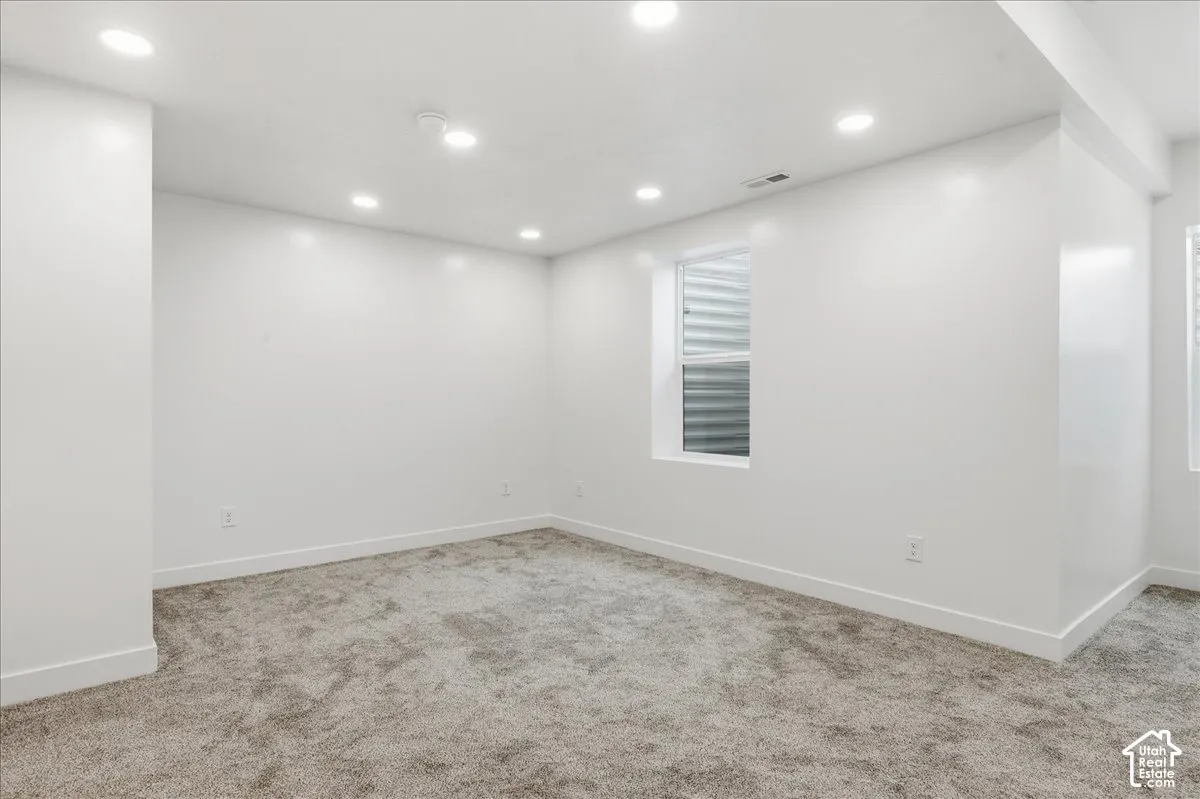 Primary Bedroom. Recessed lighting, light-toned carpeting, and white painted walls