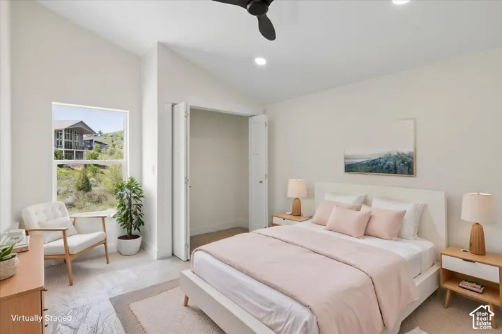 Upstairs Bedroom 2. Vaulted ceiling with recessed lighting and a ceiling fan