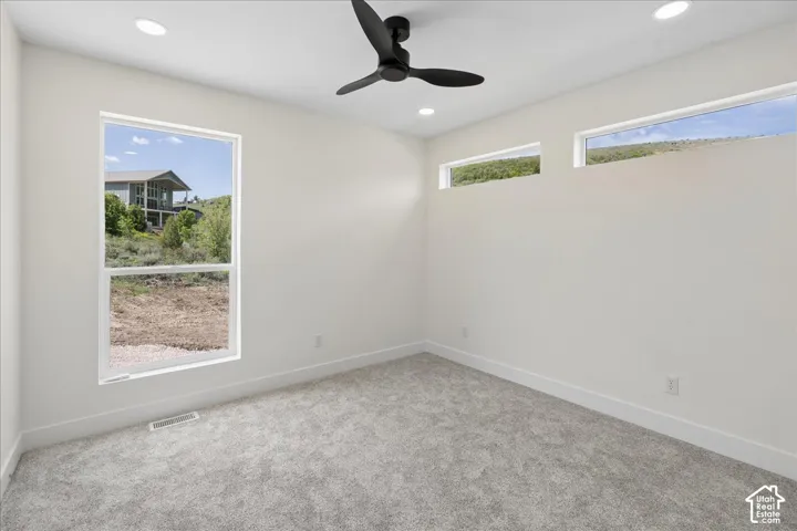 Recessed lighting, ceiling fan, and carpeted flooring