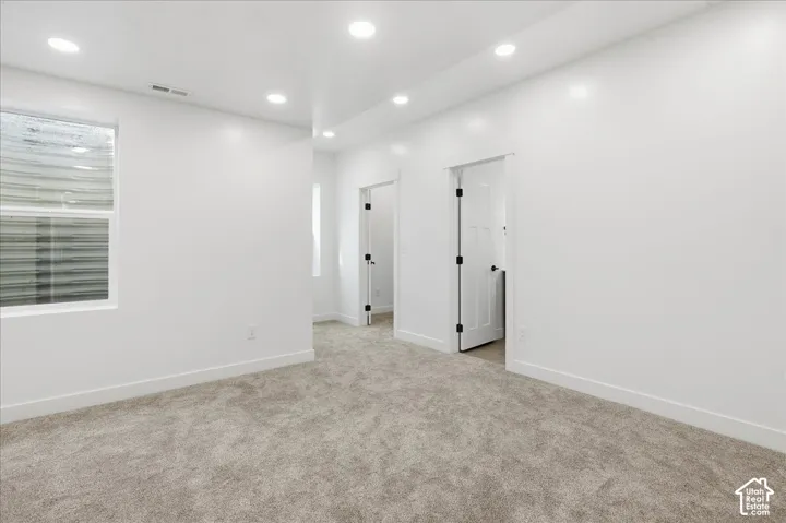 Primary bedroom showing access to master closet and bathroom
