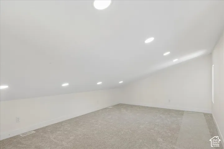 Bonus room above garage. Sloped ceiling with recessed lighting.