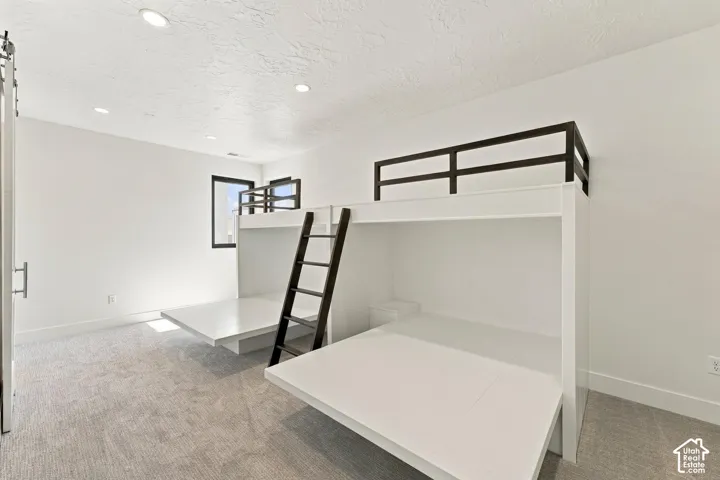 White walls with recessed lighting and a carpeted floor