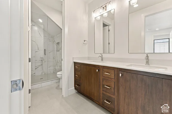 Dual vanity with wood-finish cabinetry and undermount sinks
