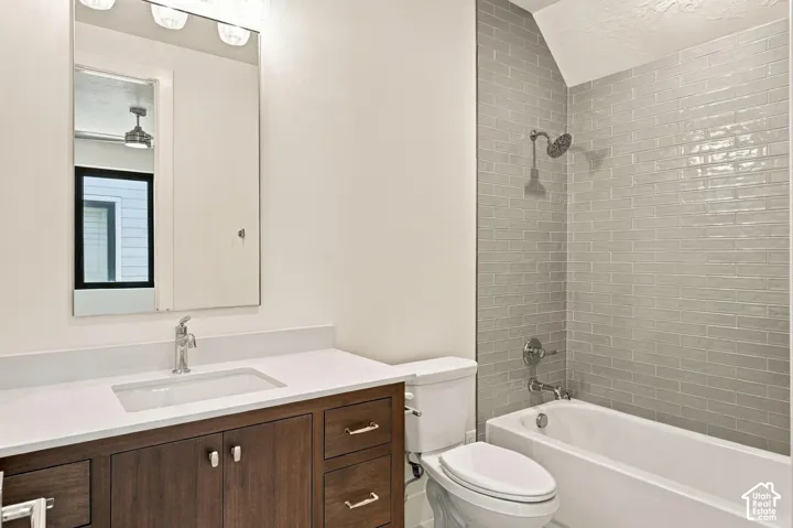 Wood-finish vanity with a white countertop and undermount sink