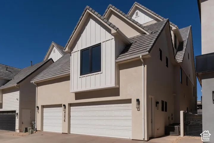 Multi-story exterior with stucco finish and vertical plank siding