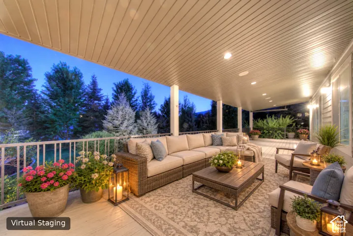 Expansive covered deck featuring recessed lighting, a slatted ceiling, and white railing