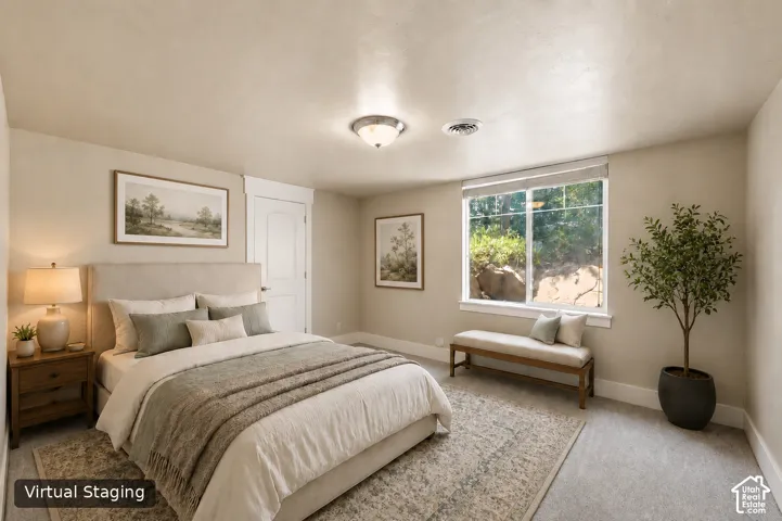 Carpeted flooring, recessed window, white trim, and a ceiling-mounted light fixture