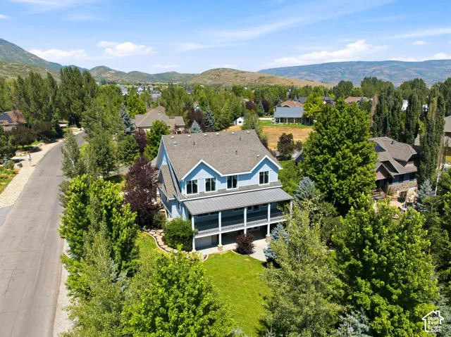 Two-story residence with a covered porch and lower-level patio