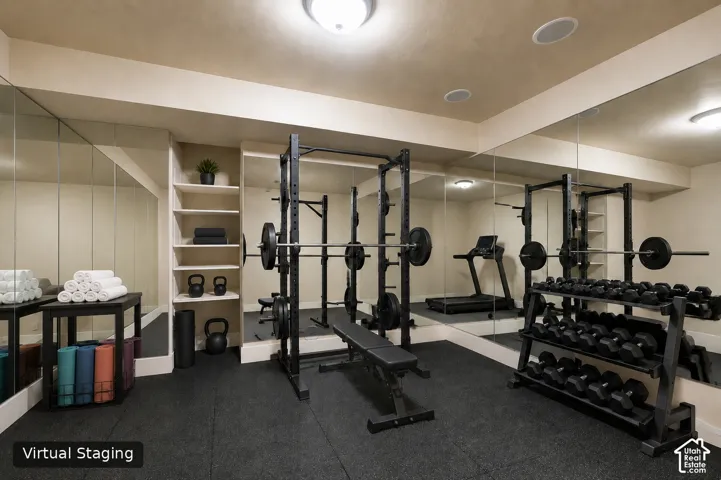 Integrated wall mirrors, recessed ceiling lighting, built-in shelving, and a durable rubber-matted floor