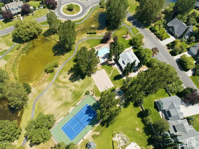Tennis court, basketball court, swimming pool, surrounding green space, and circular paths