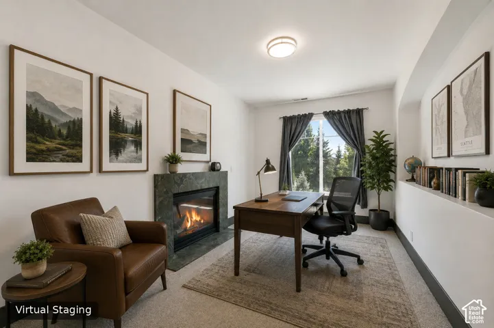 Gas fireplace with stone surround, recessed ceiling lighting, built-in shelving, window with natural light, and carpeted flooring