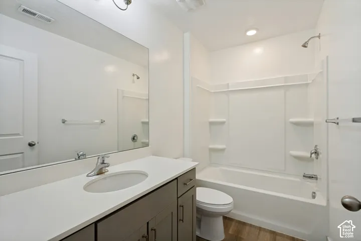 White integrated tub and shower unit with chrome fixtures