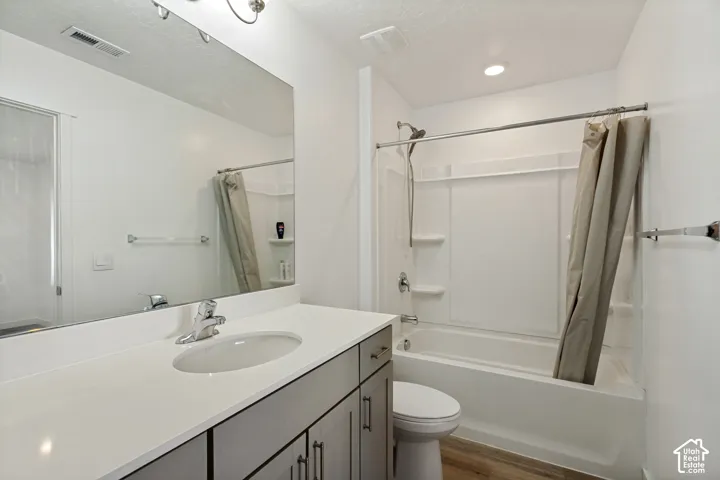Vanity with a single basin, light-toned countertop, and undermount sink