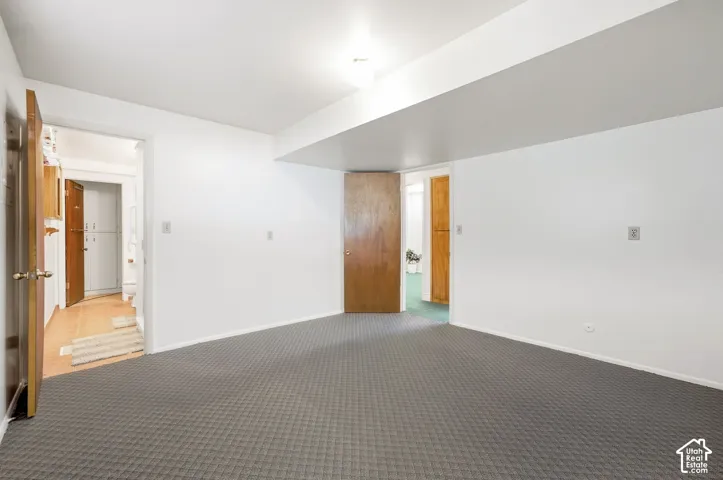 Patterned grey carpeting with white walls and a white ceiling
