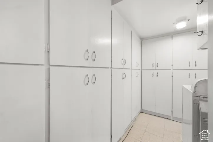 Extensive built-in white cabinetry with silver-tone hardware, providing ample storage