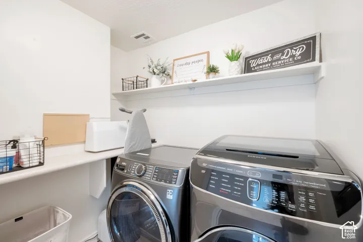Dedicated laundry area featuring a built-in countertop and upper shelving