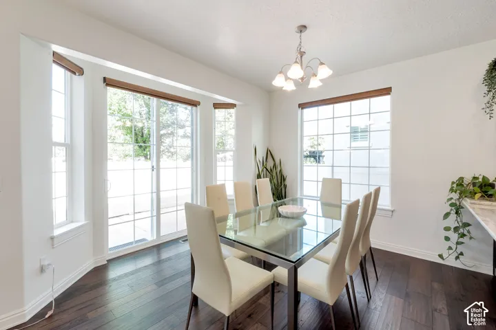 Wood-finish flooring, white walls, and a multi-pane sliding glass door with transom window