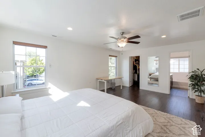 Recessed lighting, ceiling fan with light fixture, rich wood-finish flooring, and ample natural light through multiple windows