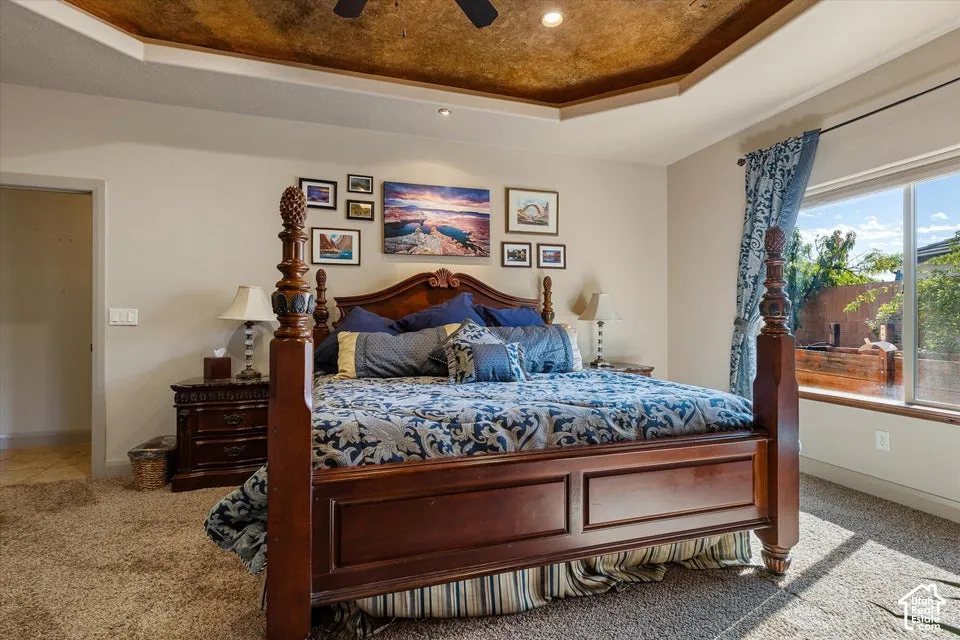 Tray ceiling with decorative finish, recessed lighting, and ceiling fan