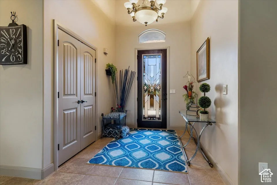 Entryway featuring tile flooring, a decorative front door with transom window, and a ceiling-mounted light fixture