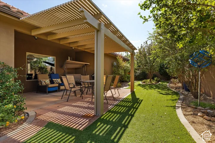 Pergola-covered patio featuring a concrete paver surface