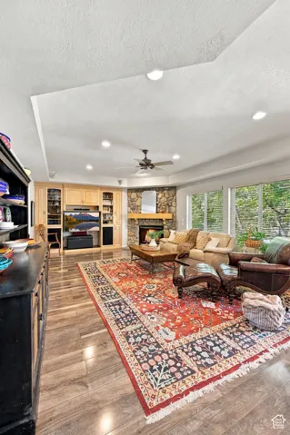 Wood-finish flooring, recessed lighting, and a tray ceiling