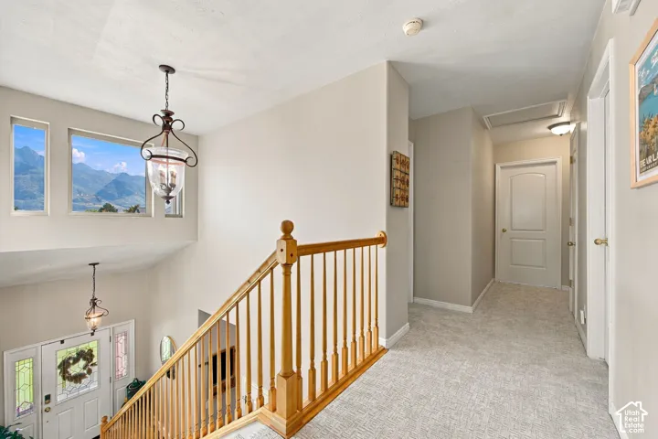 Two-story entry featuring a wood handrail and balusters, with multiple windows offering mountain scenery