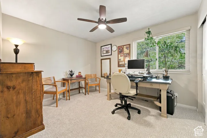 Neutral-toned walls, ceiling fan with integrated lighting, light-colored carpeting, and window with blinds