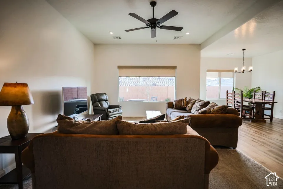 Vaulted ceilings with recessed lighting, wood-finish flooring, and a ceiling fan