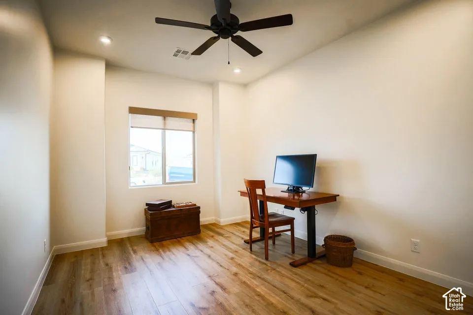 Wood-finish flooring, recessed lighting, and ceiling fan