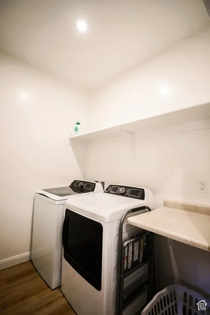 Utility space featuring wood-finish flooring, white walls, and a built-in white shelf