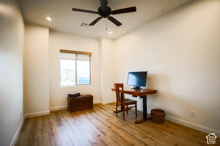 Wood-finish flooring, recessed lighting, and ceiling fan