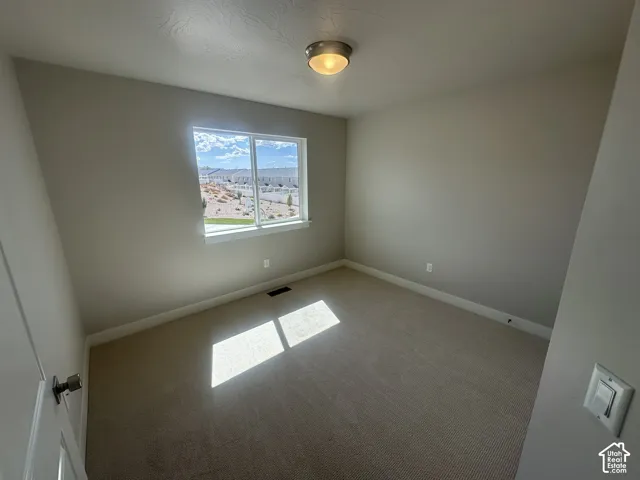 Recessed window with white trim, wall-to-wall carpeting, neutral wall paint, and a ceiling-mounted light fixture