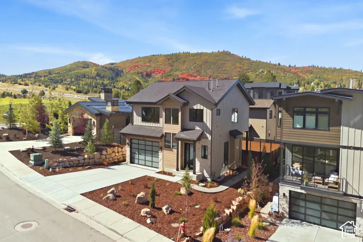 Modern architectural style with a multi-paneled garage door and a paved driveway