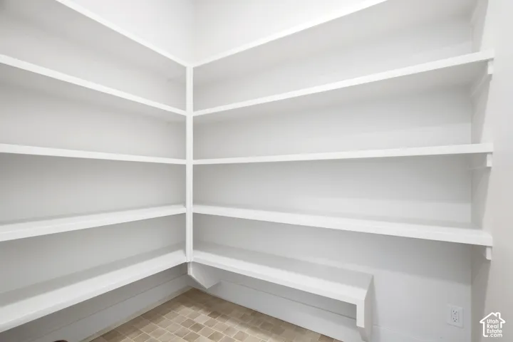 Built-in shelving with white finish, corner configuration, and tile flooring
