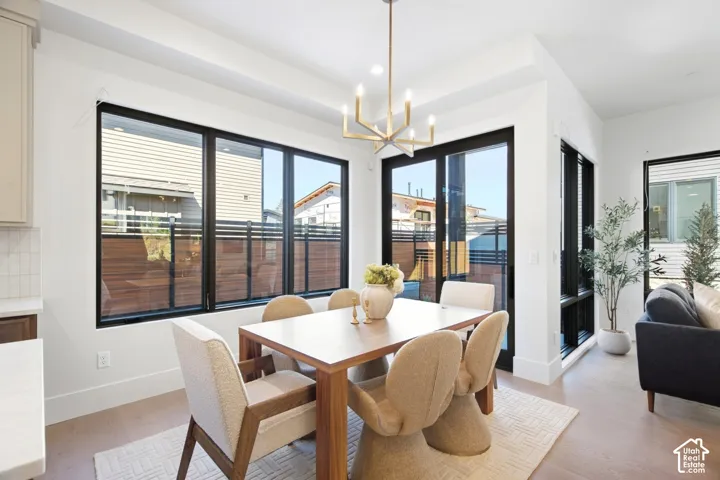 Recessed lighting, wood-finish flooring, and white walls