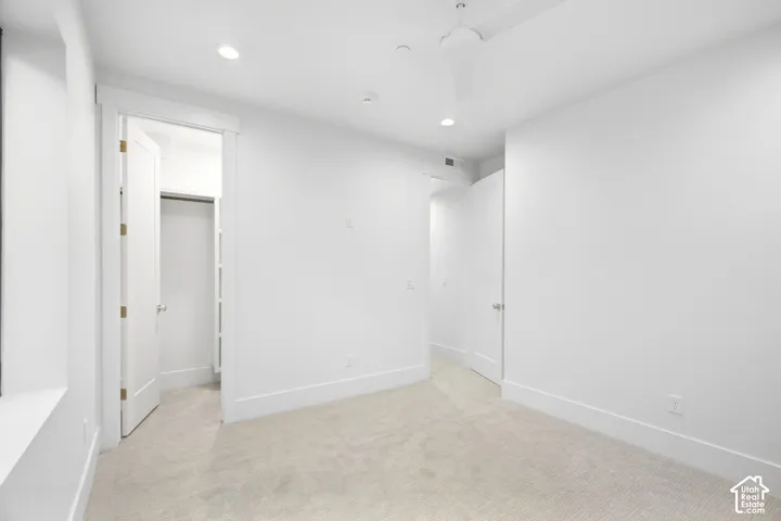 White walls, recessed lighting, ceiling fan, and carpeted flooring