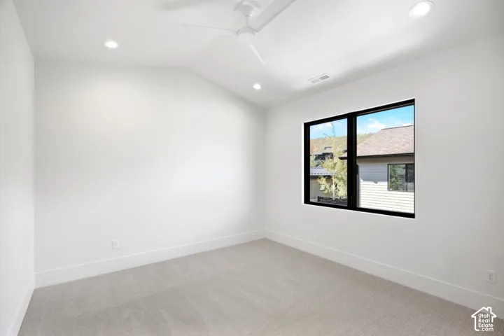 Recessed lighting, wall-to-wall carpeting, and a black-framed window