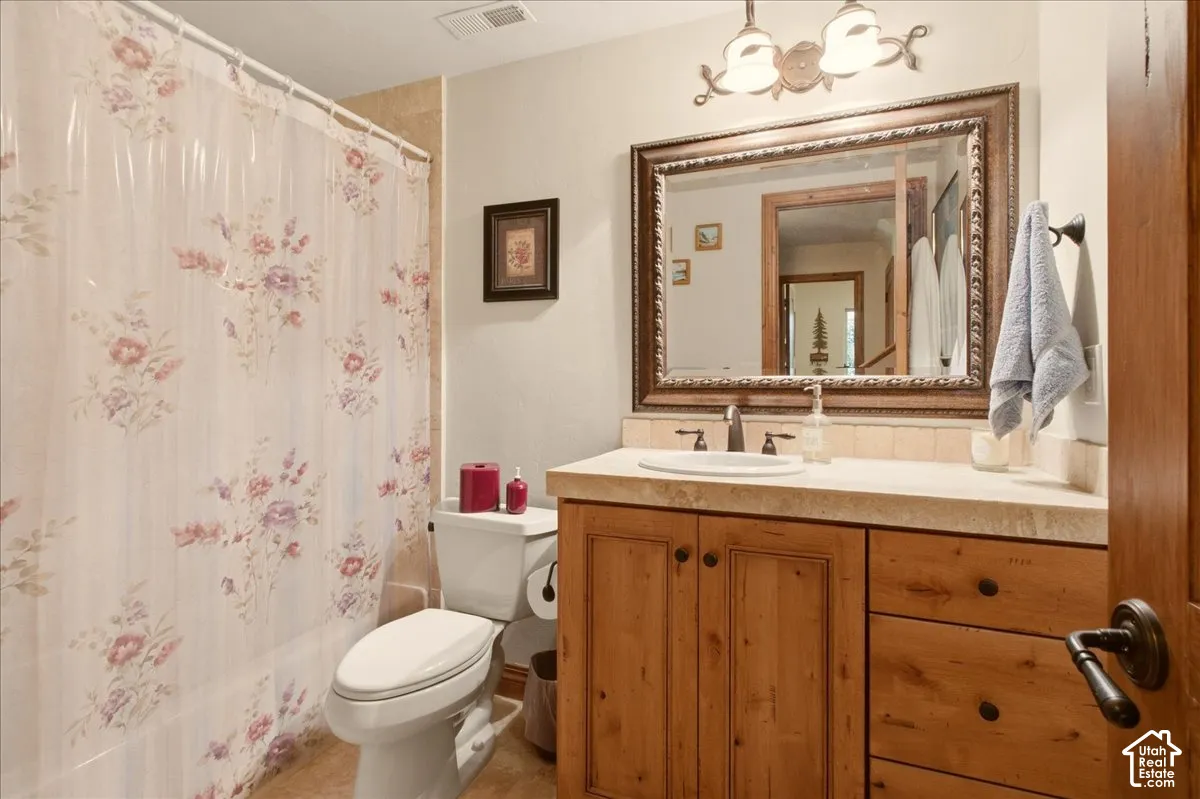 Wood-finish vanity with an integrated sink and stone countertop