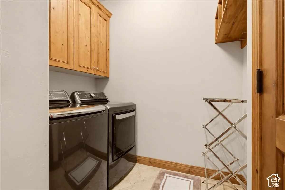 Wood cabinetry, wood door, tiled flooring, wood trim