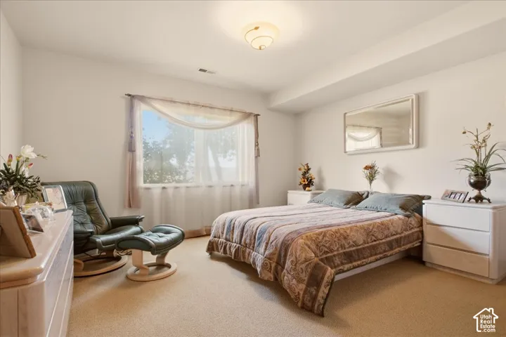 Carpeted bedroom featuring a large window with a spectacular view