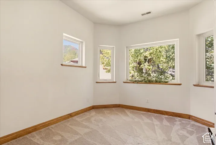 Bedroom/office featuring multiple windows with wood-finish sills