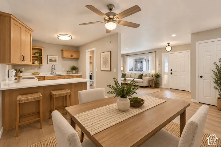 Open-concept living space featuring wood-finish flooring and light-toned walls