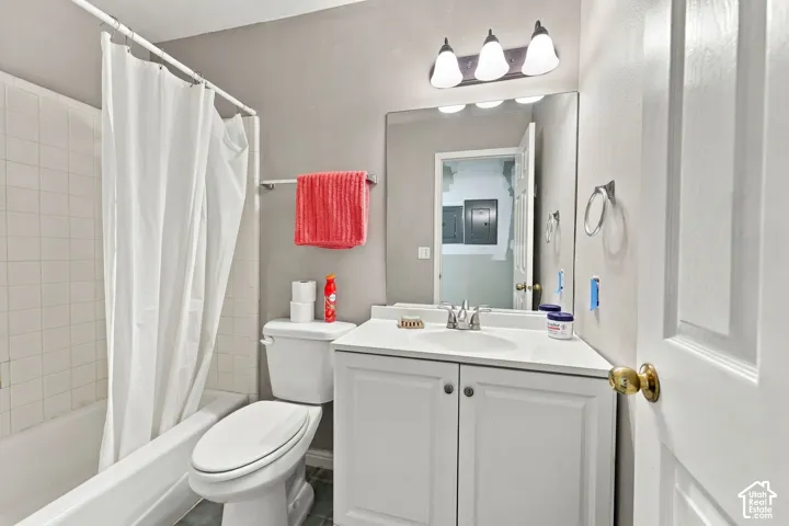 White vanity with integrated sink, chrome faucet, and overhead lighting