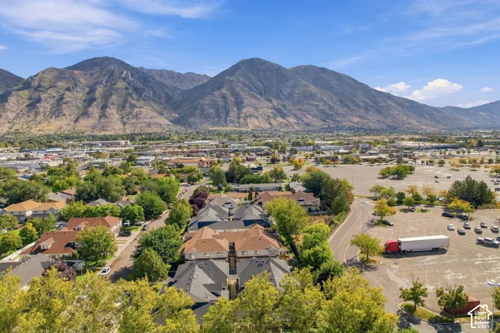 Expansive mountain backdrop with a residential neighborhood and commercial buildings